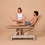 Nuuna 2L Pro Electric Treatment Table: 2 sections with 1 motor, 360° perimeter control, adjustable backrest and Naggura Skin upholstery (various colors) Nuuna 2L Pro Electric Treatment Table: 2 sections with 1 motor, 360° perimeter control, adjustable backrest and Naggura Skin upholstery (various colors)